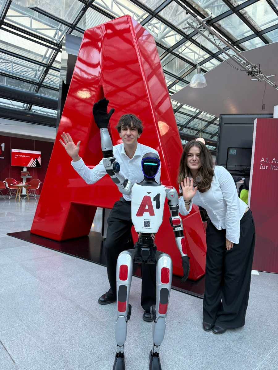 Junge Besucher mit Unitree G1 Event Robot vor dem roten A1 Logo